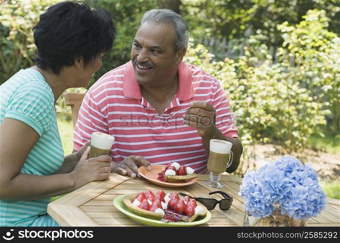 Side profile of a mature woman sitting with a senior man at the breakfast table