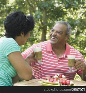 Side profile of a mature woman smiling with a senior man at the breakfast table