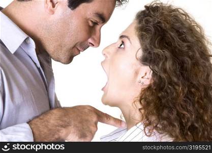 Side profile of a mid adult man and a young woman arguing