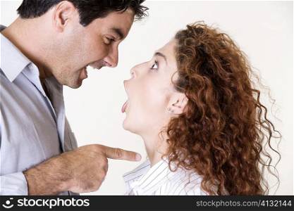Side profile of a mid adult man and a young woman arguing