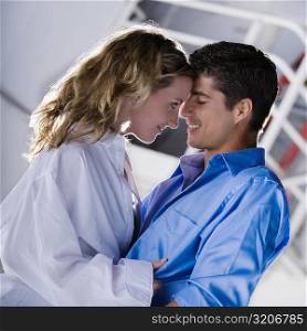 Side profile of a mid adult man and a young woman looking at each other