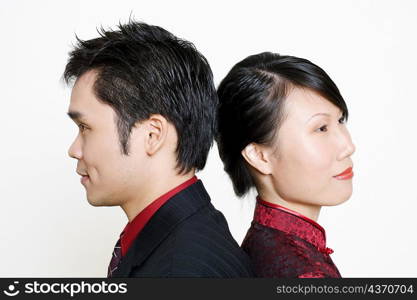 Side profile of a mid adult man and a young woman smiling