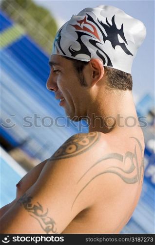 Side profile of a mid adult man at the poolside