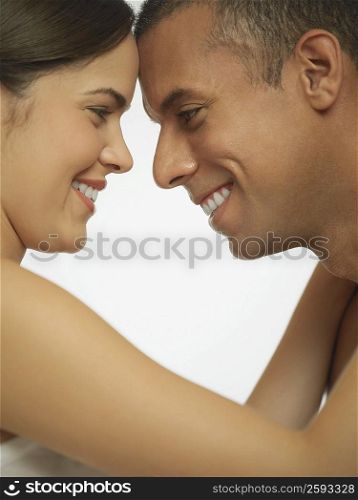 Side profile of a mid adult man looking at a young woman