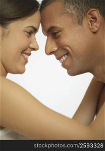 Side profile of a mid adult man looking at a young woman