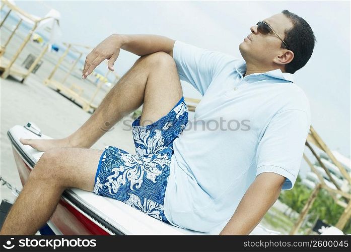 Side profile of a mid adult man sitting on a boat