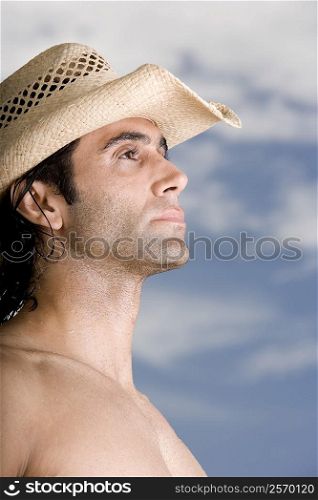 Side profile of a mid adult man wearing a hat