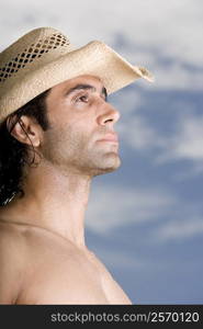 Side profile of a mid adult man wearing a hat