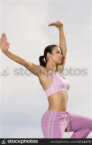 Side profile of a mid adult woman exercising