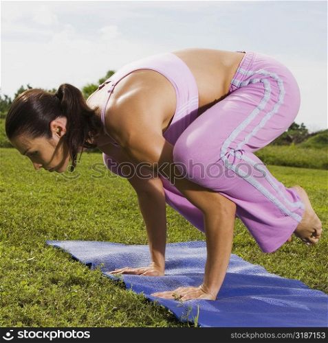 Side profile of a mid adult woman in a yoga position