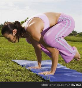 Side profile of a mid adult woman in a yoga position