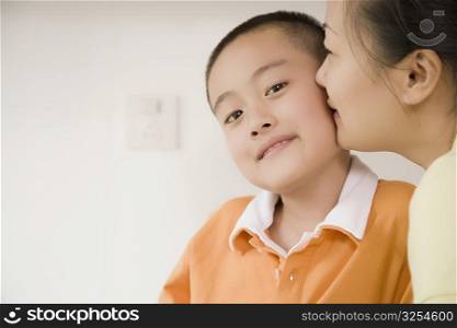 Side profile of a mid adult woman kissing her son