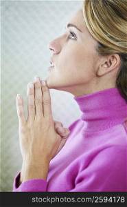 Side profile of a mid adult woman praying
