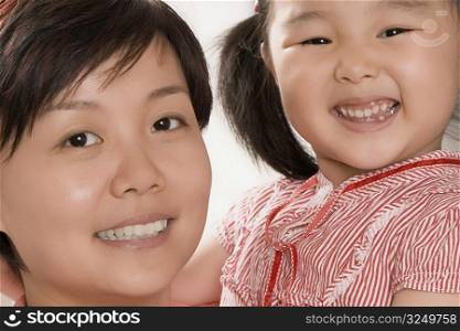 Side profile of a mid adult woman smiling with her daughter