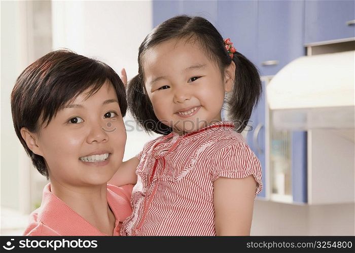 Side profile of a mid adult woman smiling with her daughter