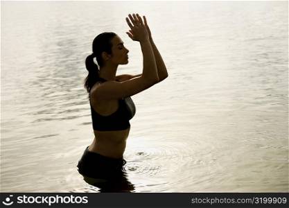 Side profile of a mid adult woman standing in water