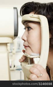 Side profile of a patient being examined with an ophthalmoscope