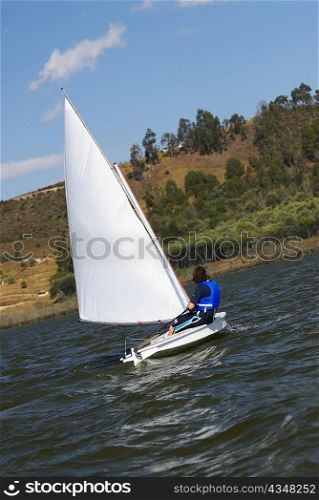 Side profile of a person participating in a sailboat race