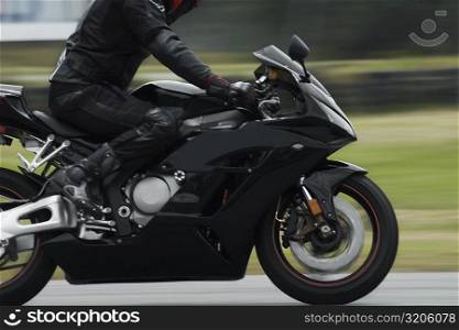 Side profile of a person riding a motorcycle