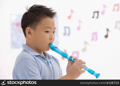 Side profile of a schoolboy playing a flute