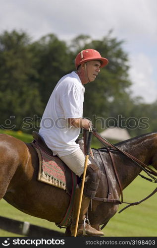 Side profile of a senior man playing polo