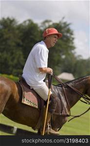 Side profile of a senior man playing polo