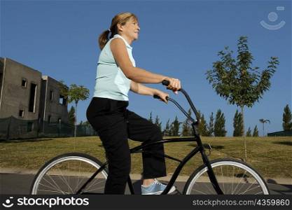 Side profile of a senior woman cycling