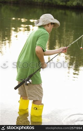 Side profile of a teenage boy holding a fishing rod
