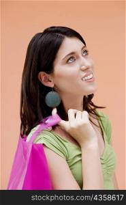 Side profile of a teenage girl holding a shopping bag