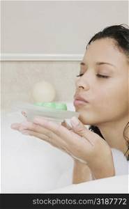 Side profile of a teenage girl holding a soap dish