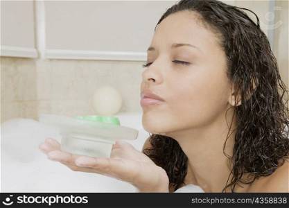 Side profile of a teenage girl holding a soap dish