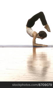 Side profile of a woman doing handstand