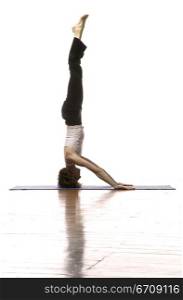 Side profile of a woman doing headstand