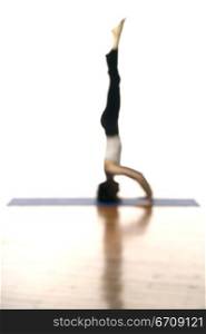Side profile of a woman doing headstand