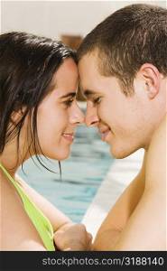 Side profile of a young couple at the poolside