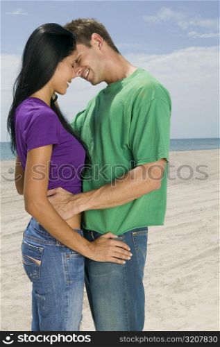 Side profile of a young couple embracing each other