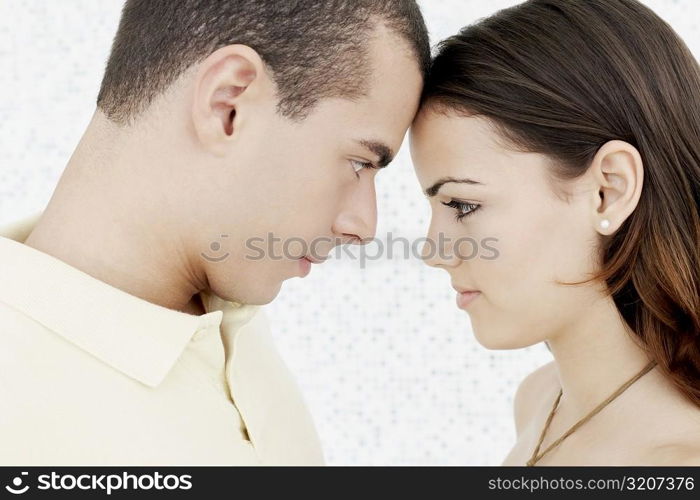 Side profile of a young couple face to face