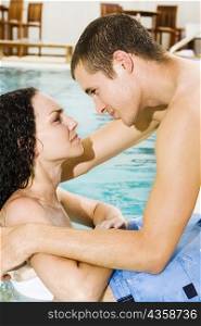 Side profile of a young couple in a swimming pool