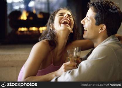 Side profile of a young couple laughing