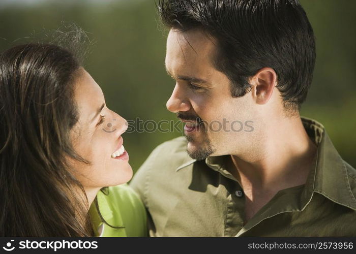 Side profile of a young couple looking at each other