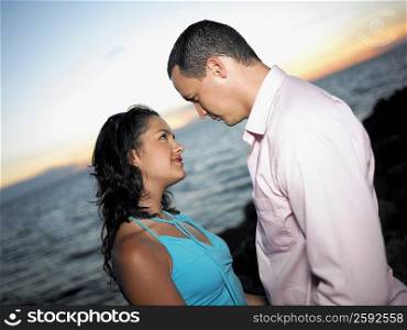Side profile of a young couple looking at each other