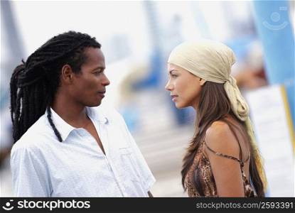 Side profile of a young couple looking at each other