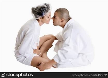 Side profile of a young couple nuzzling