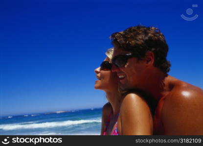 Side profile of a young couple on the beach