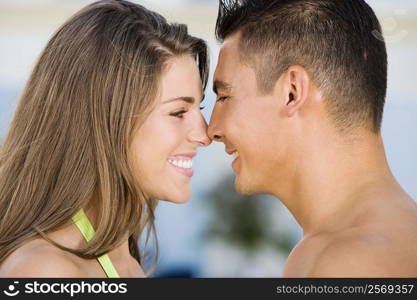 Side profile of a young couple rubbing their noses