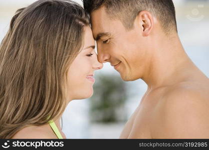 Side profile of a young couple rubbing their noses