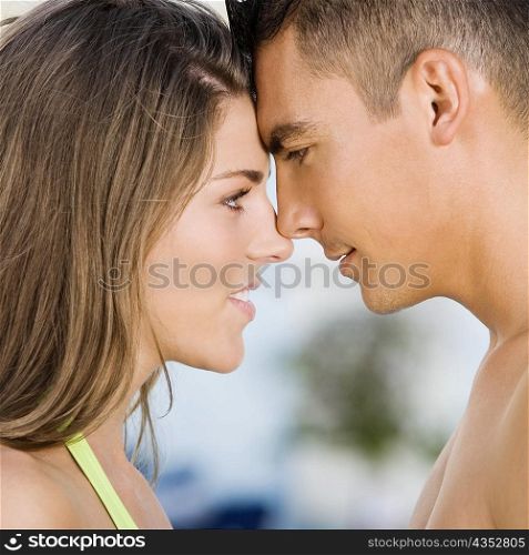 Side profile of a young couple rubbing their noses