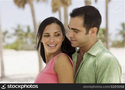 Side profile of a young couple smiling
