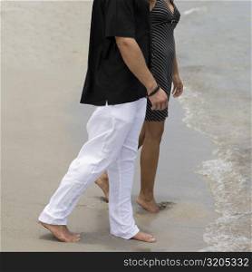 Side profile of a young couple walking on the beach
