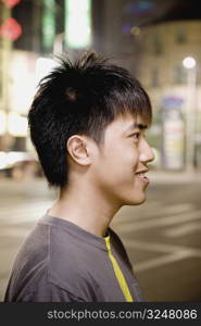 Side profile of a young man smiling